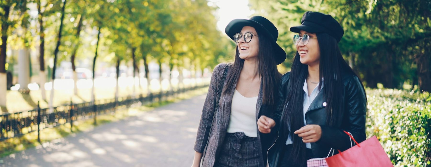 two women smiling in a park