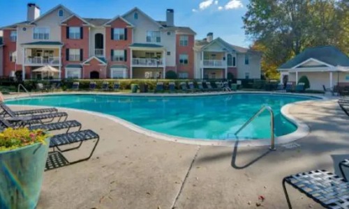 a swimming pool in front of a building