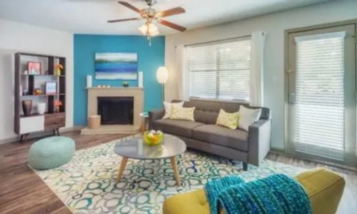 a living room with a couch, coffee table and fireplace
