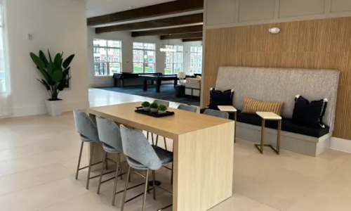 a clubroom with a table and chairs