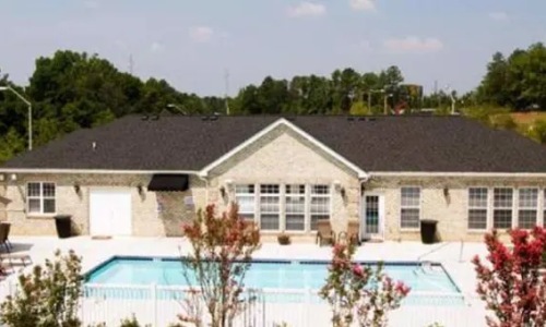 a swimming pool in front of a building
