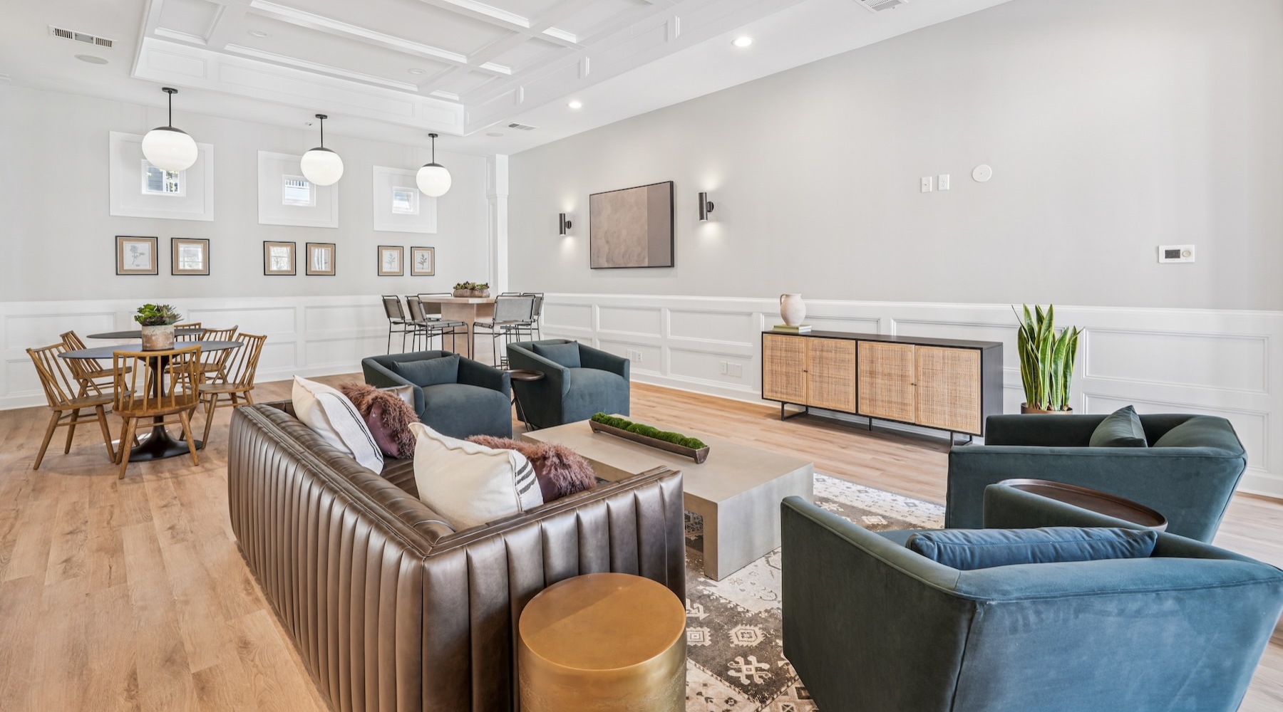 a clubroom with a couch, tables and chairs