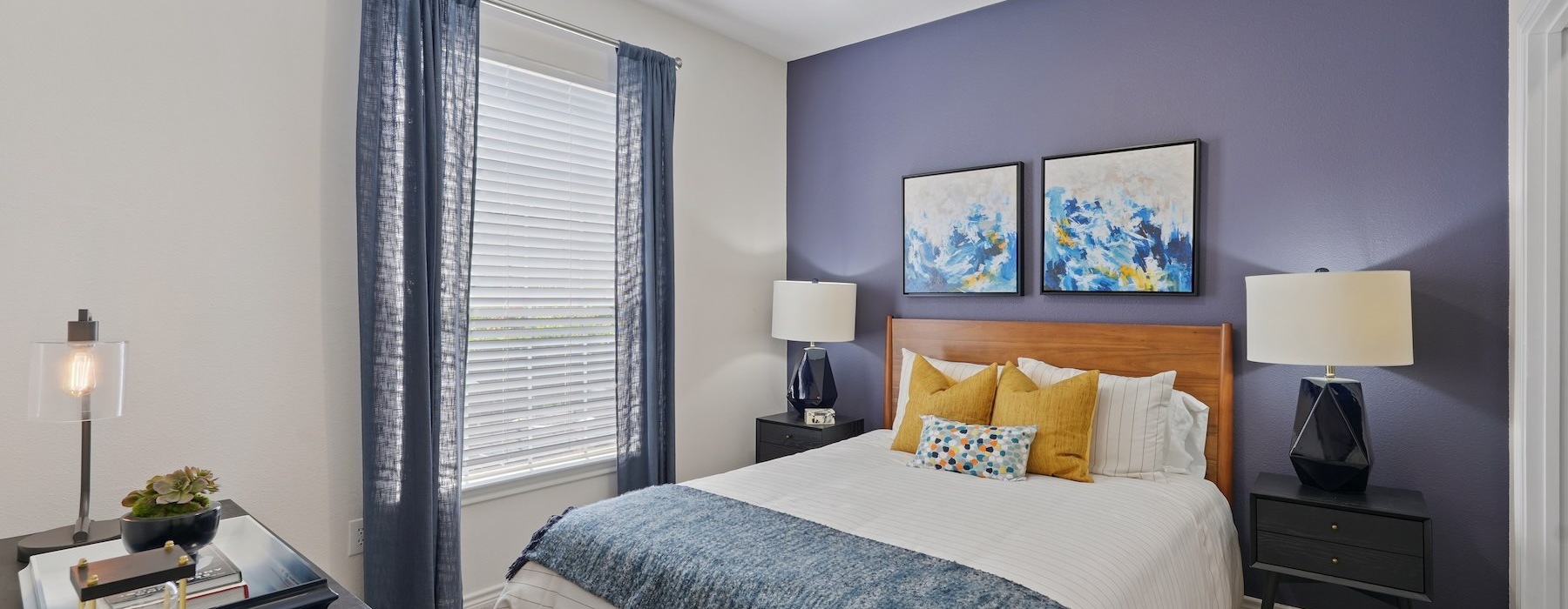 a bedroom with a fan and a bed