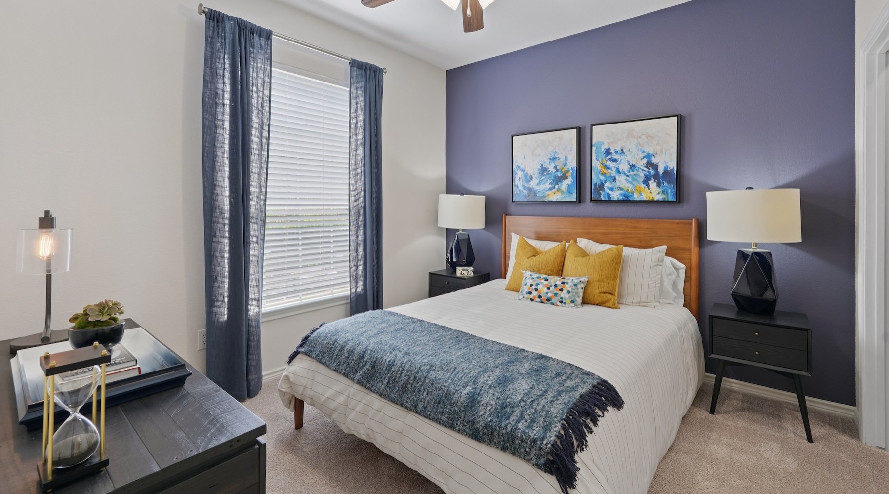a bedroom with a fan and a bed