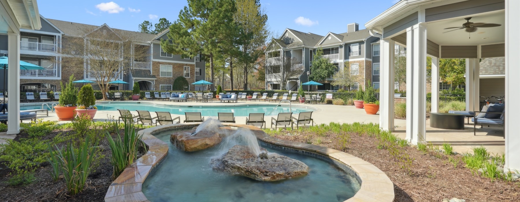 a water fountain in front of a pool